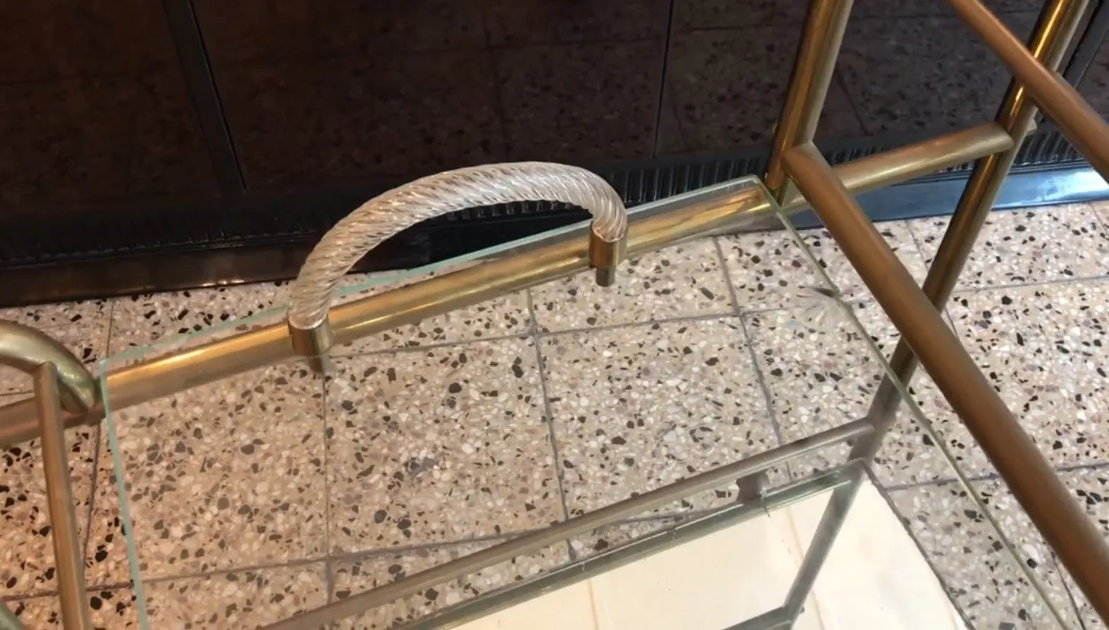 Antique cocktail trolley with an elegant design and rope handle, perfect for any living room.
