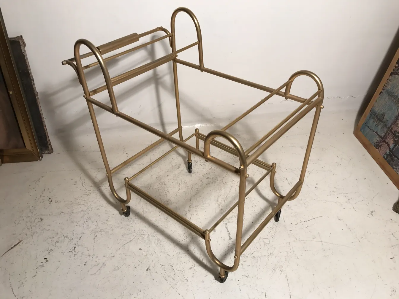 Antique cocktail trolley with a gold frame, perfect for drinks.