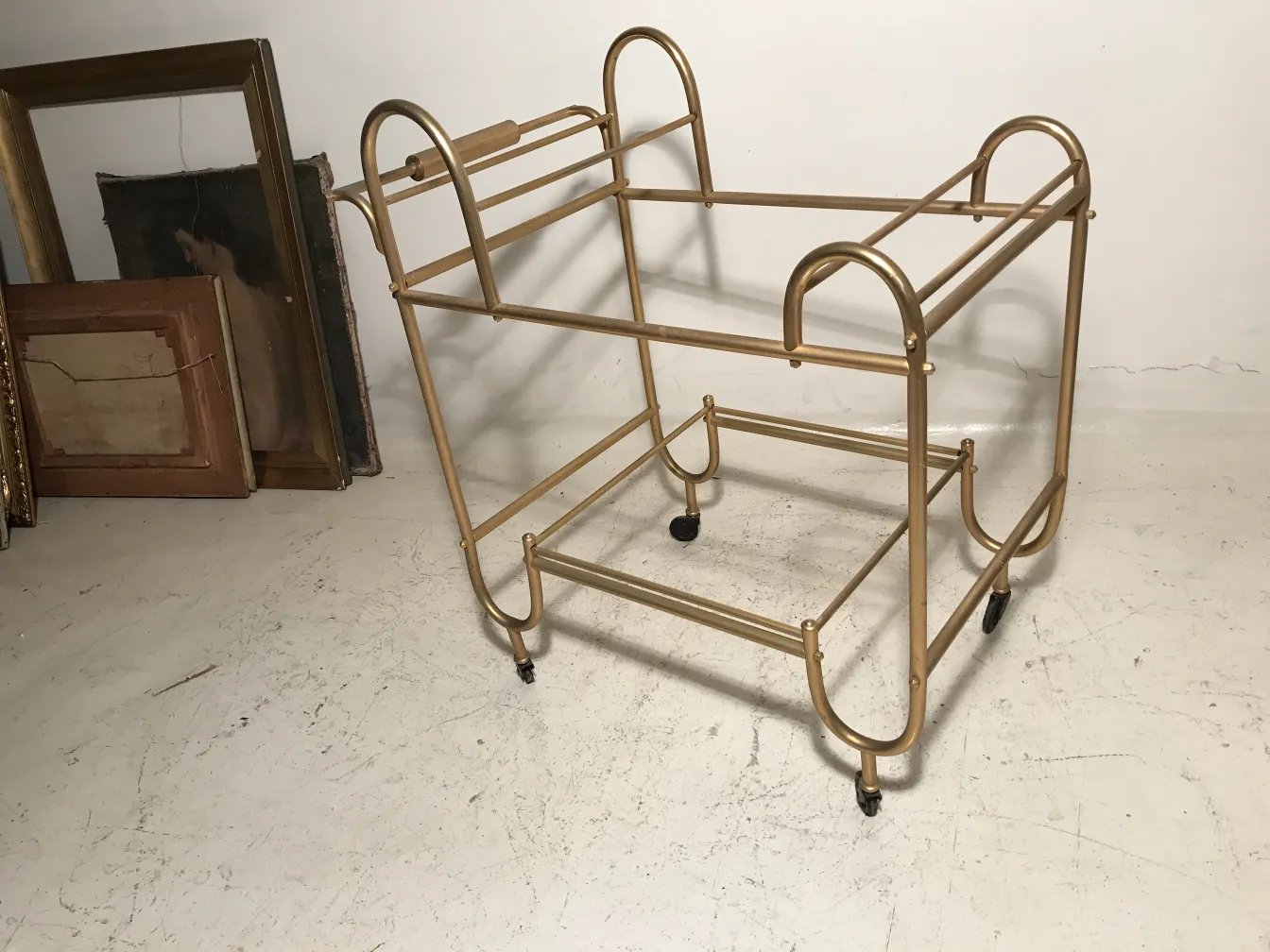 Antique cocktail trolley with golden metal frame and wheels