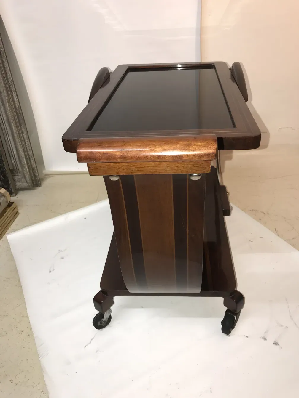 Antique cocktail trolley with a rich wood finish and wheels