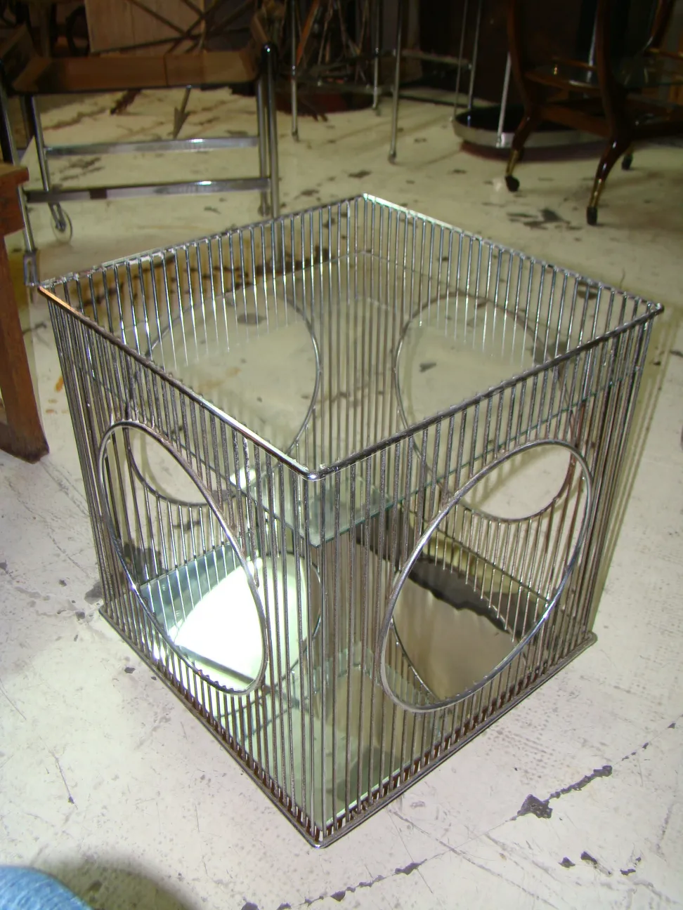 Antique cocktail trolley warren platner seen in a light environment with other furniture in the background.