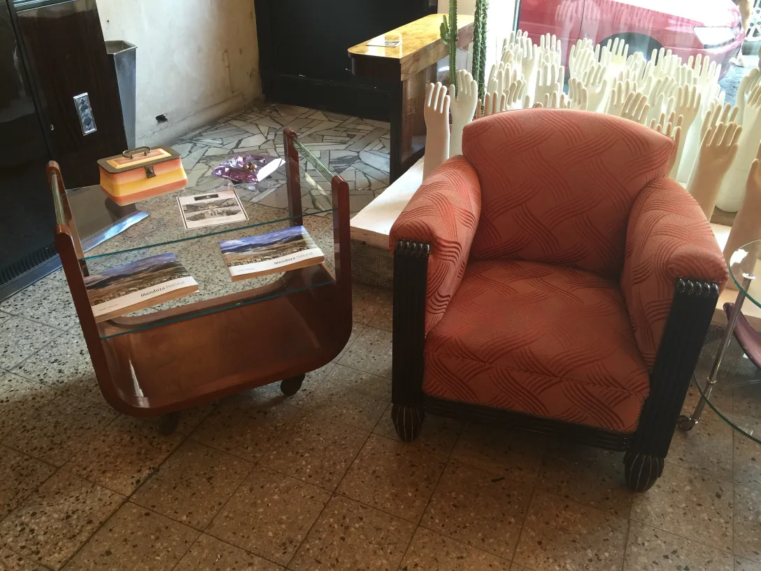 Antique cocktail trolley with glass top and wheels, set in a retro environment.