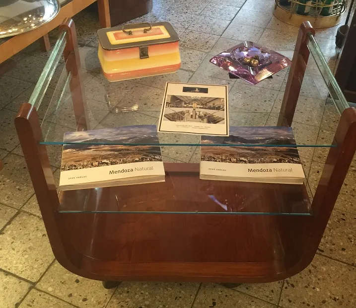 Antique cocktail trolley with glass shelves and magazines
