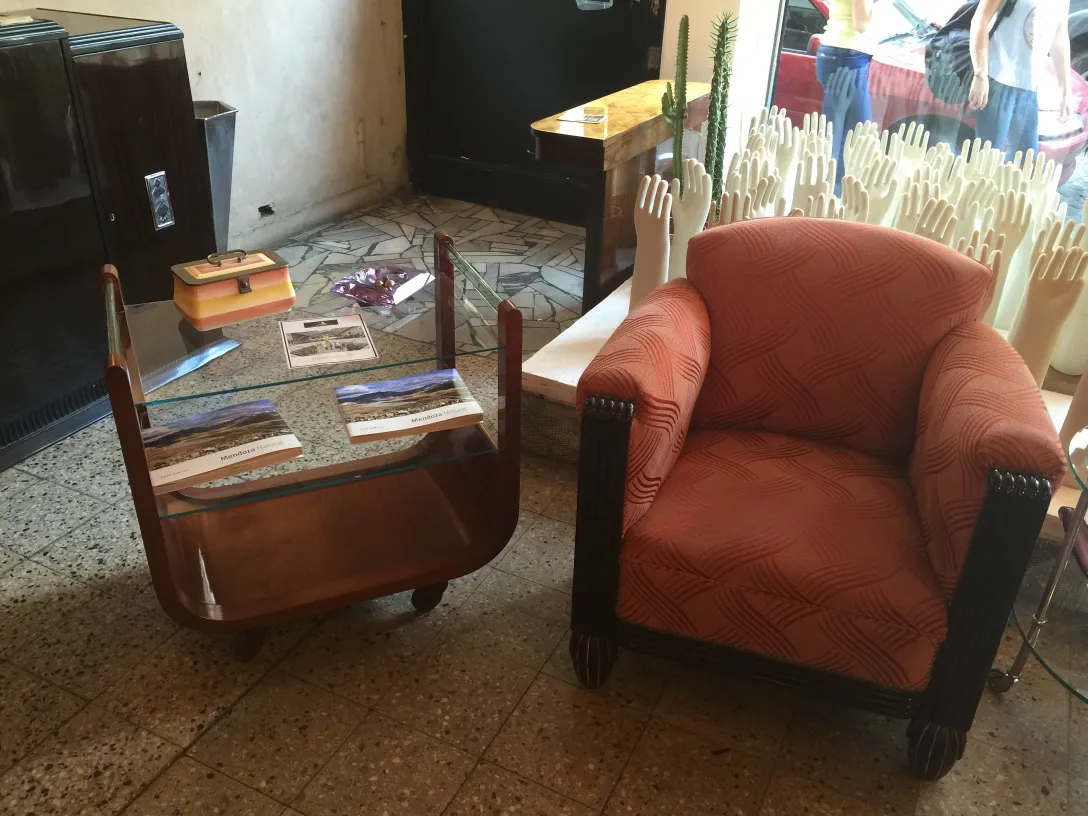 Antique cocktail trolley with wooden base and glass top.