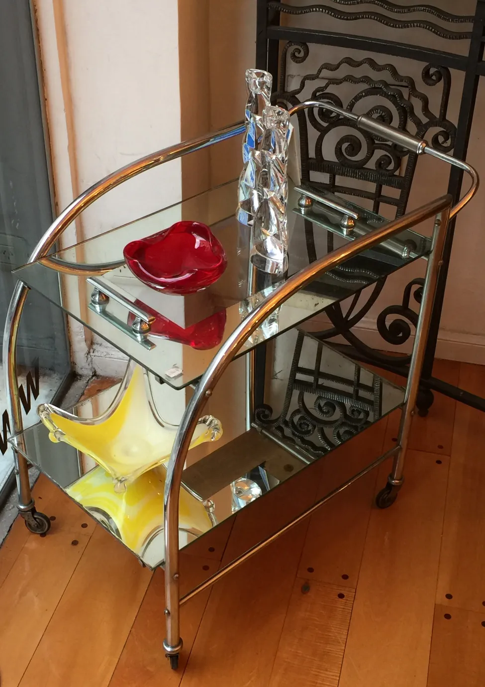Antique cocktail trolley with glass decorations in red and yellow.