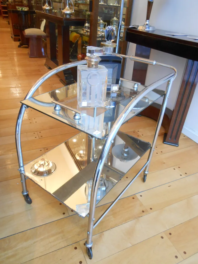 Antique cocktail trolley with mirror shelves and elegant decor.
