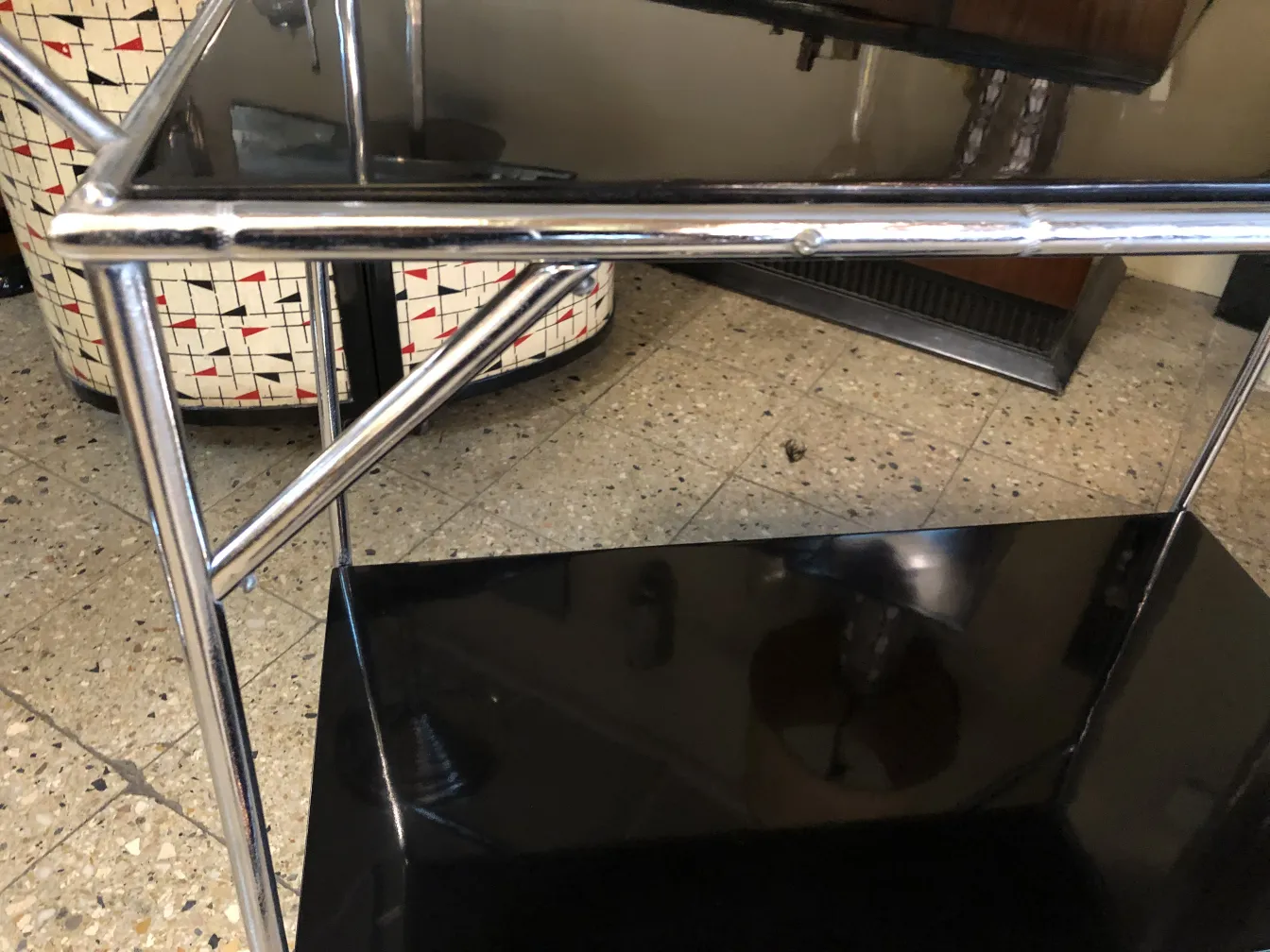 Antique cocktail trolley with black finish and metal frame.