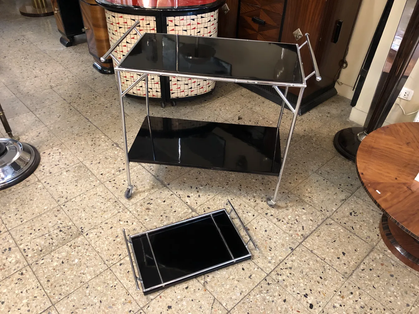 Antique cocktail trolley with two black shelves.