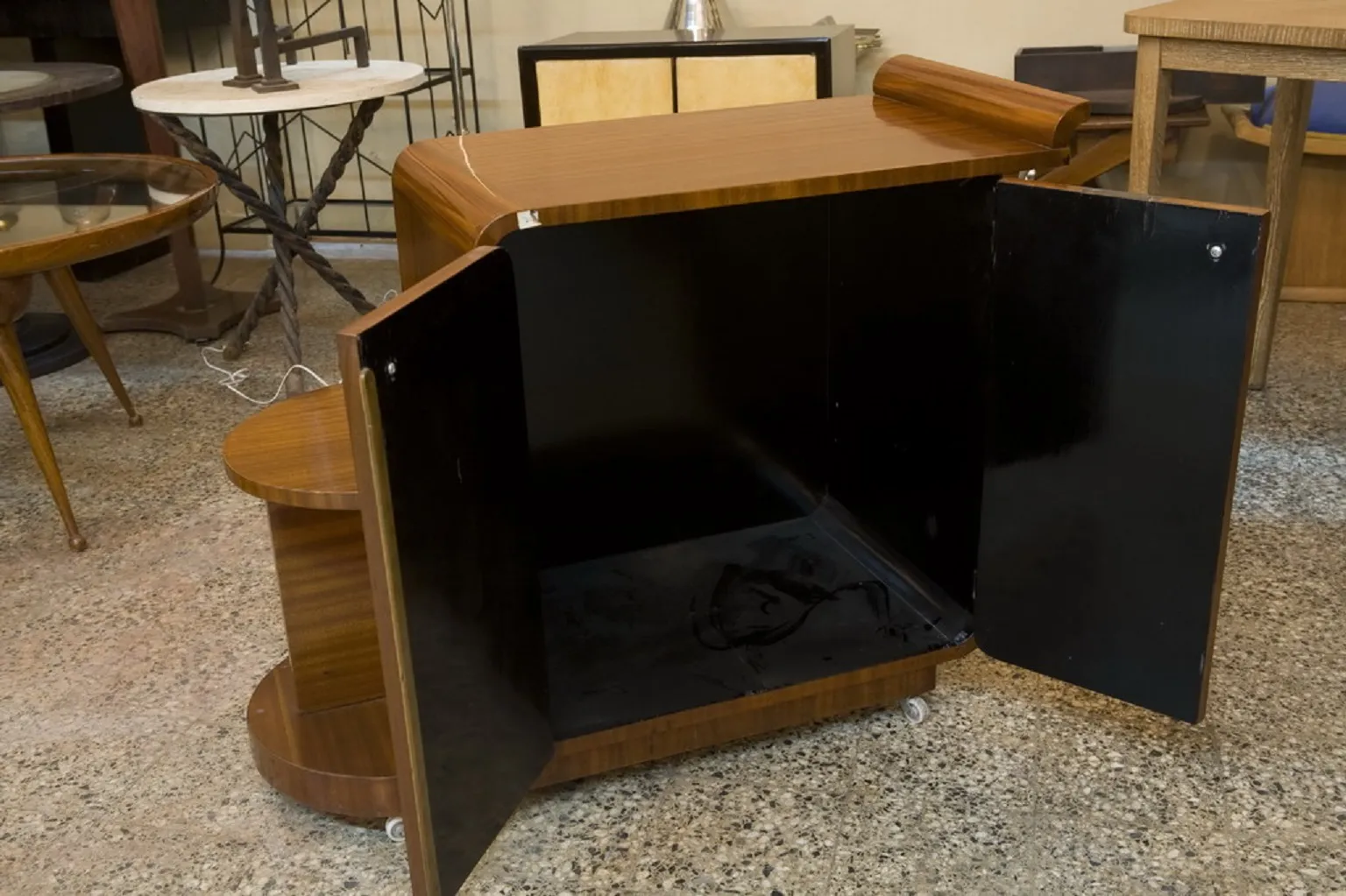 Antique cocktail trolley with brown finish and storage doors, set in a vintage environment