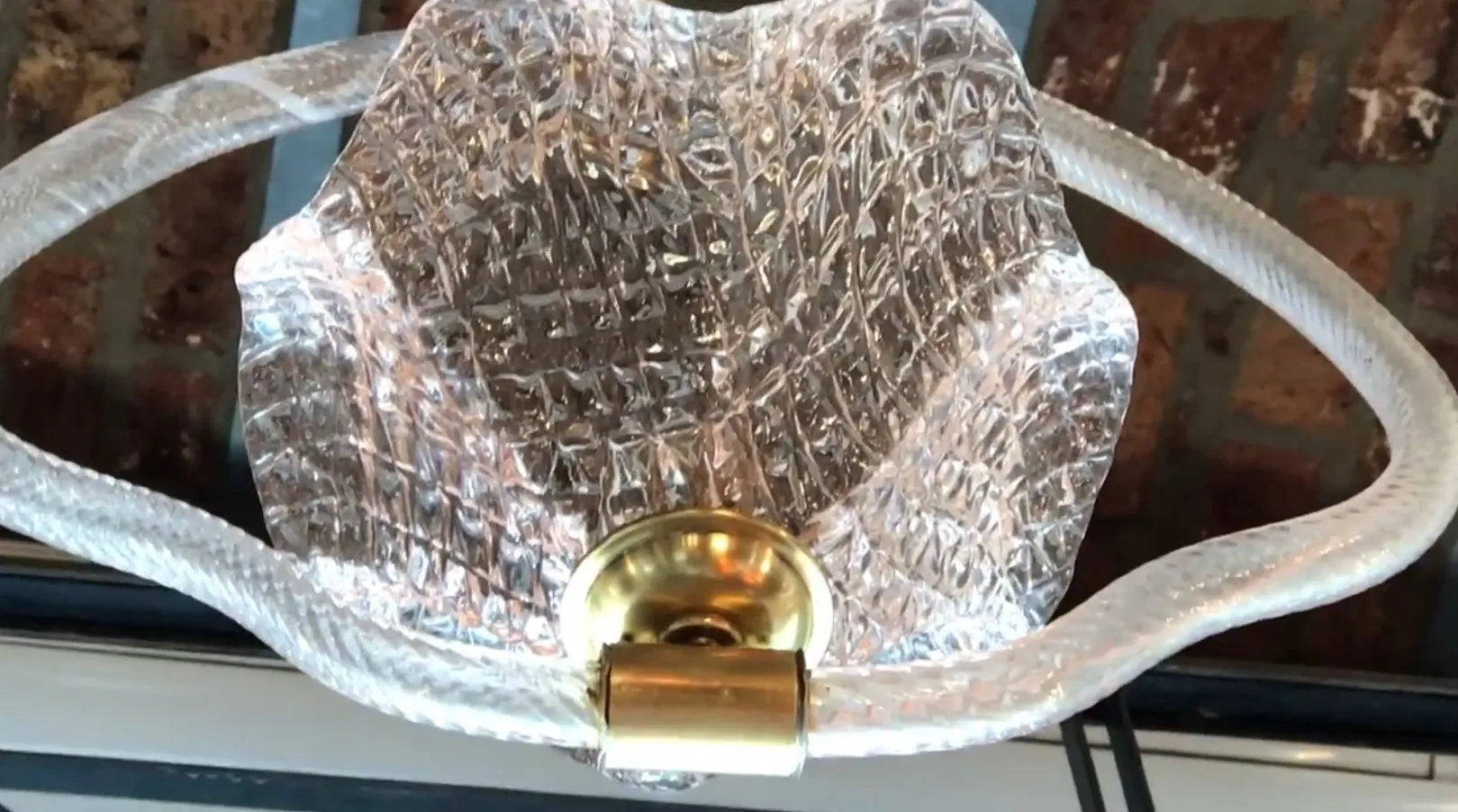 Antique hanging lamp with a translucent shade and gold base, creating a warm ambiance.