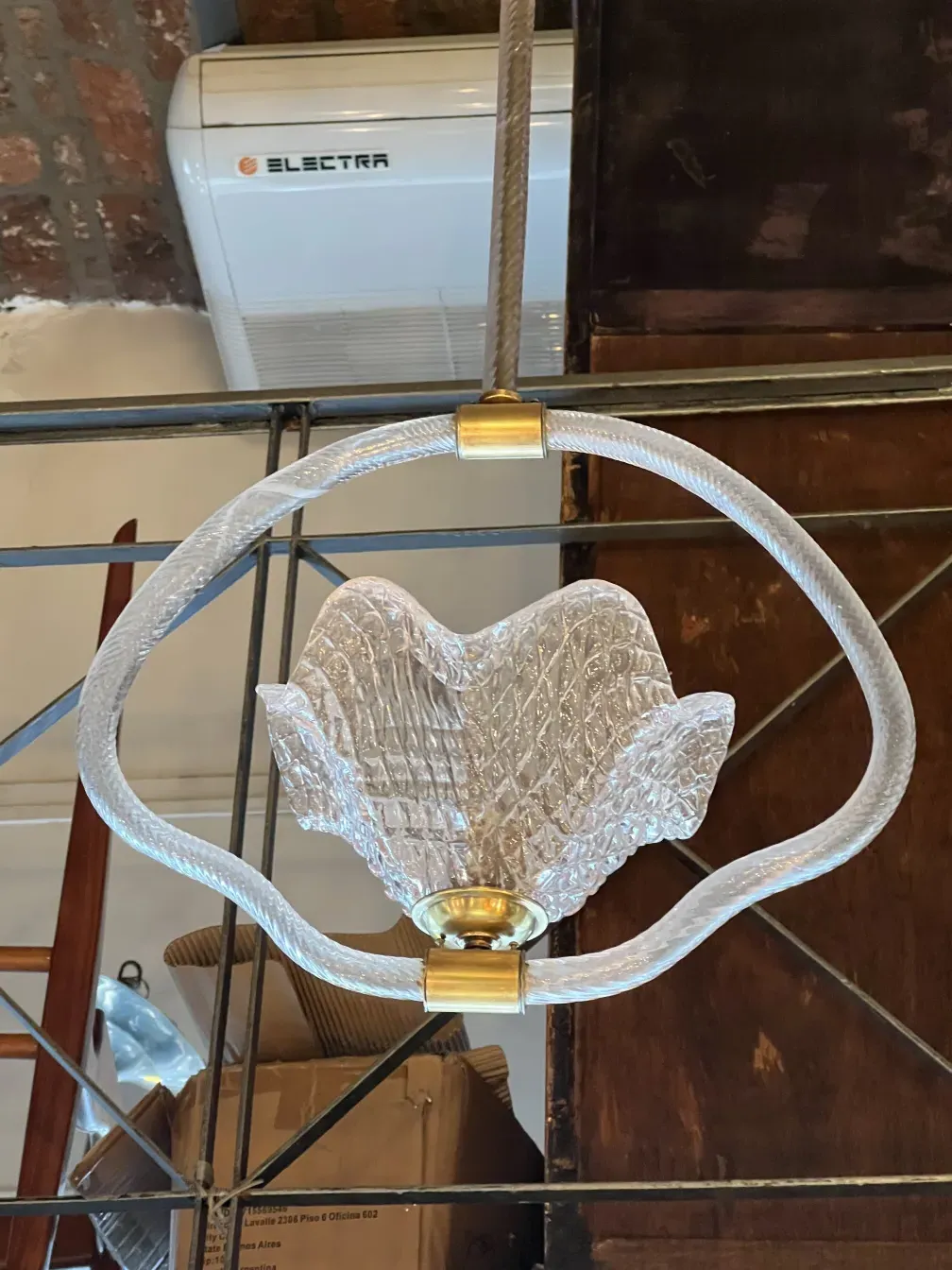 Hanging lamp with unique and elegant design in a cozy environment.