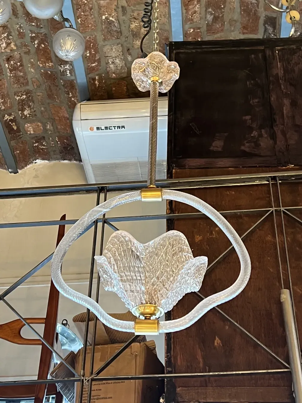 Antique hanging lamp with clear glass details in a rustic environment