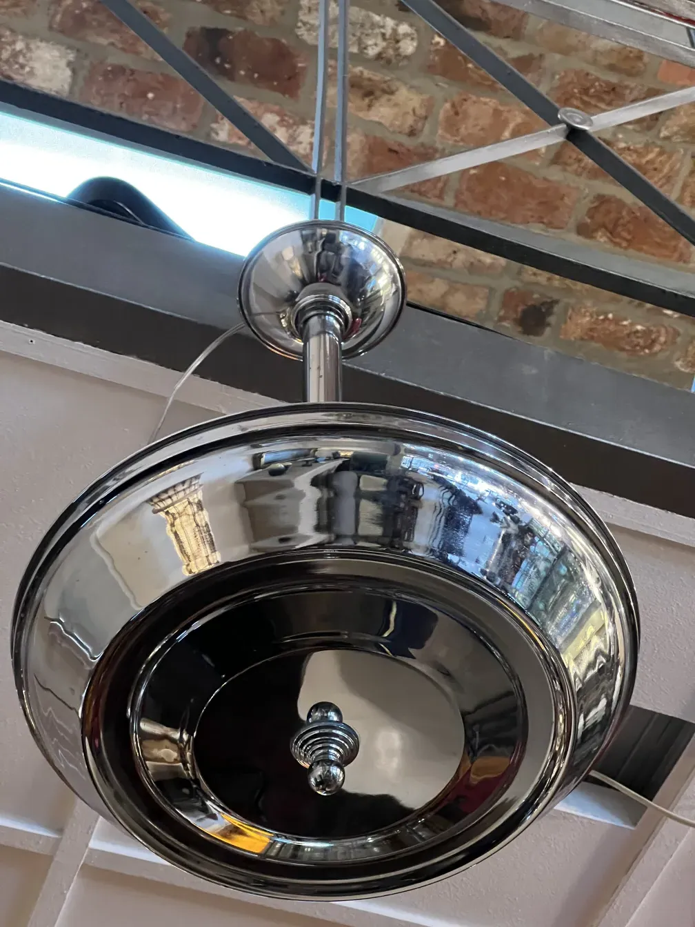 Antique hanging lamp with a shiny finish, elegant ambiance.