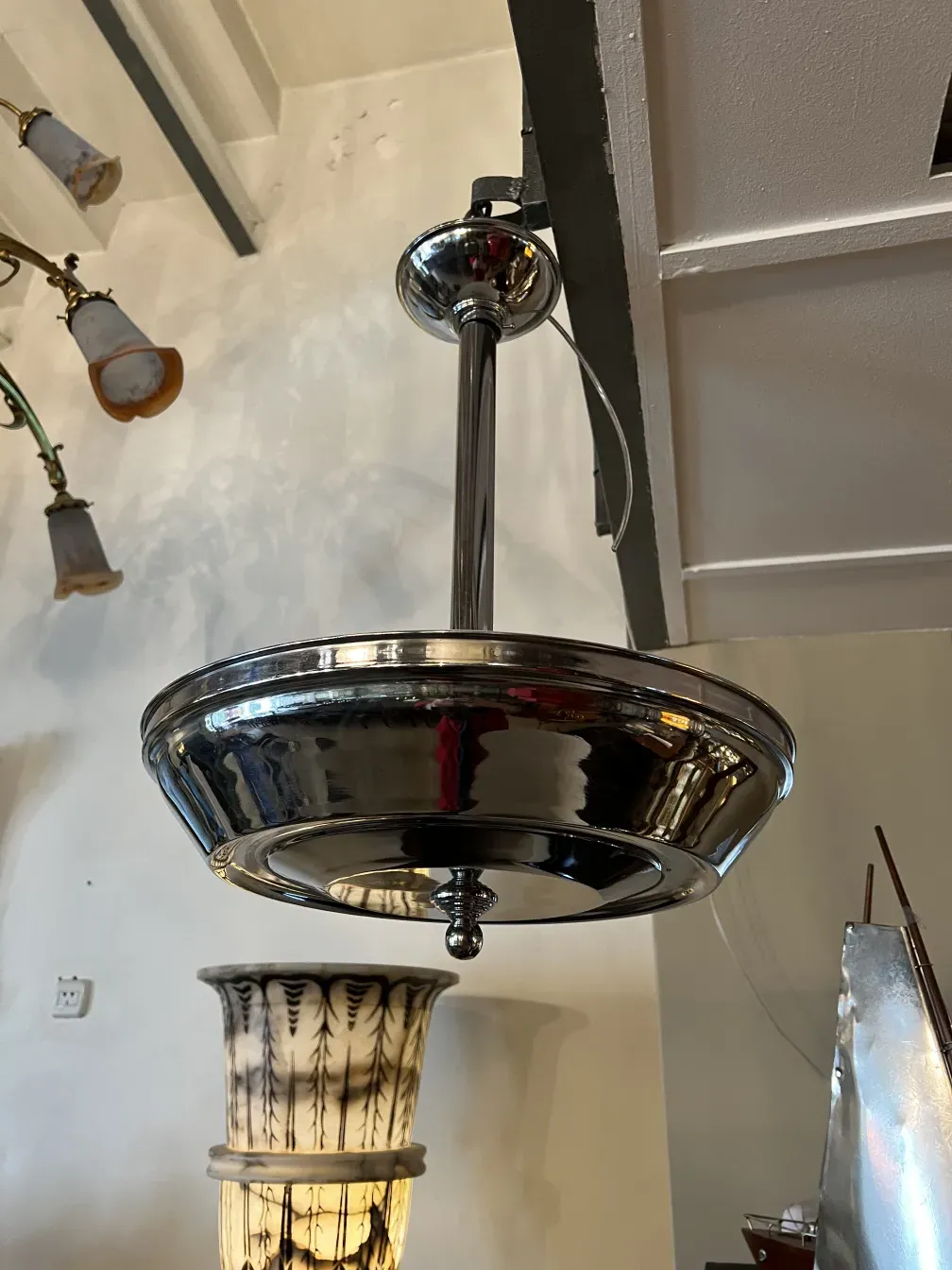 Antique shiny hanging lamp, elegant ambiance with other decorative elements.