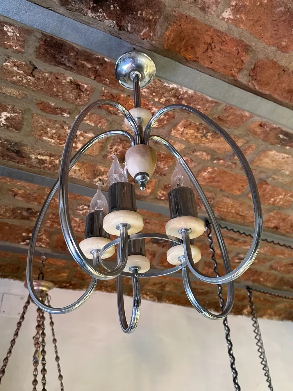 Antique hanging lamp with unique design in a brick setting