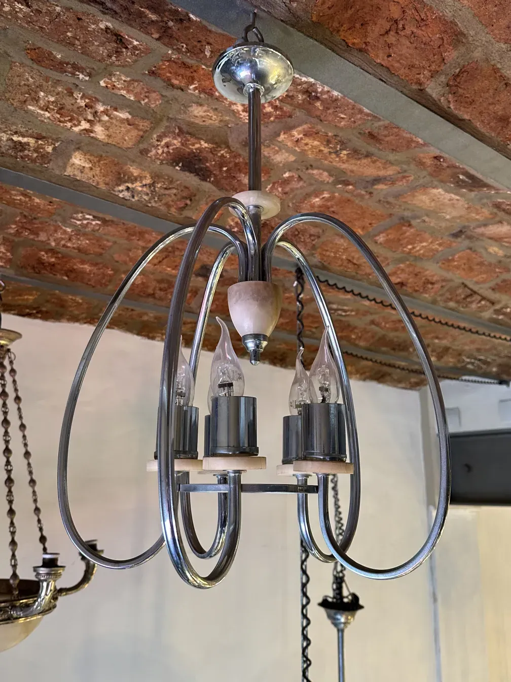 Antique hanging lamp with a modern, elegant design, surrounded by a cozy atmosphere.