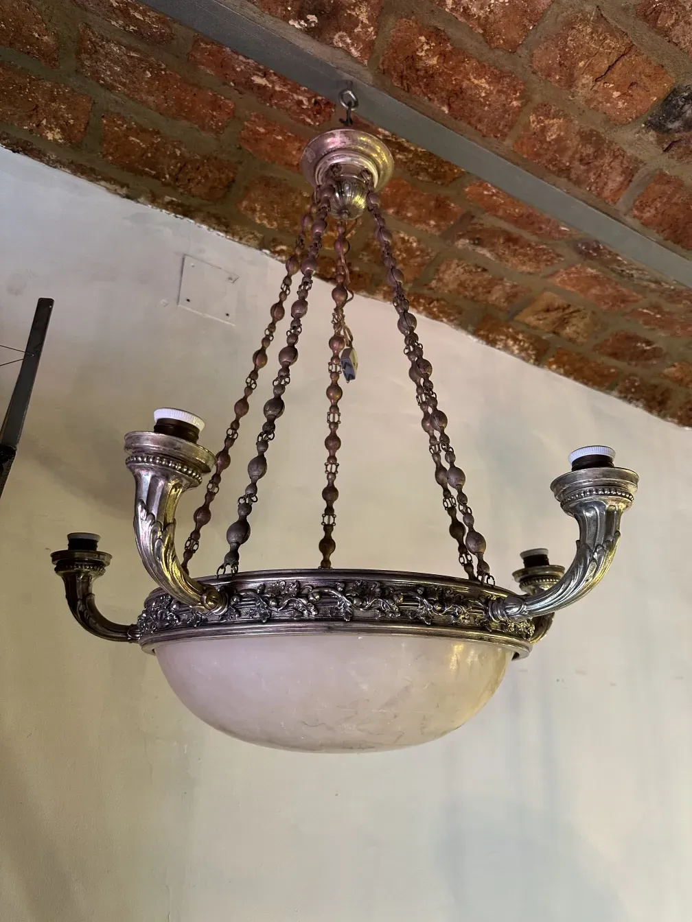 Antique hanging lamp, featuring decorative chains and an elegant base.