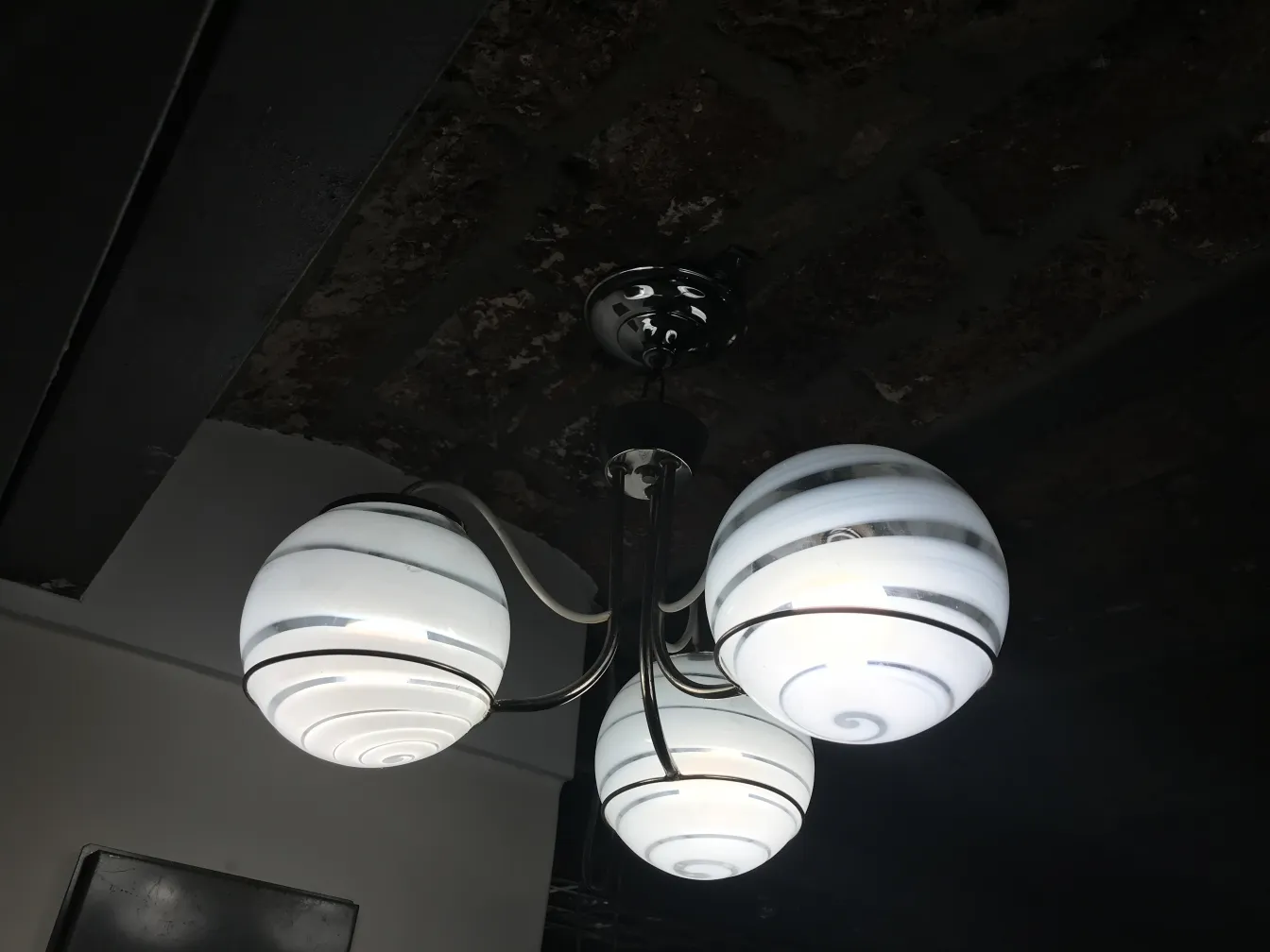 Antique hanging lamp with white spheres in a modern setting