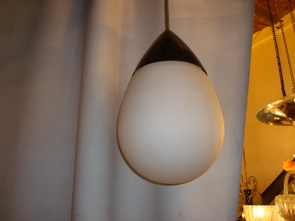 Antique hanging lamp with elegant shape illuminating a vintage setting.