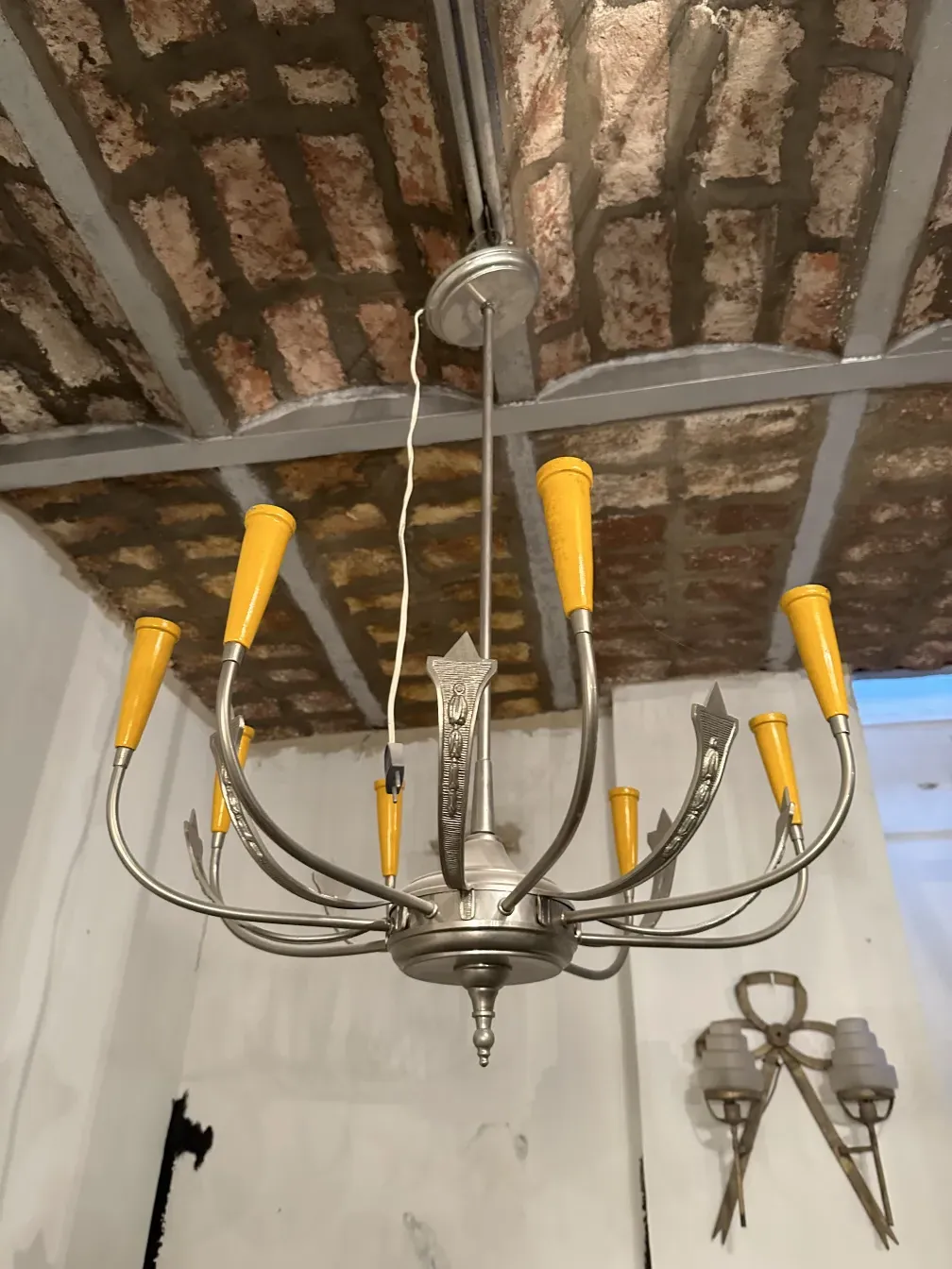 Antique hanging lamp featuring yellow shades in a rustic setting.