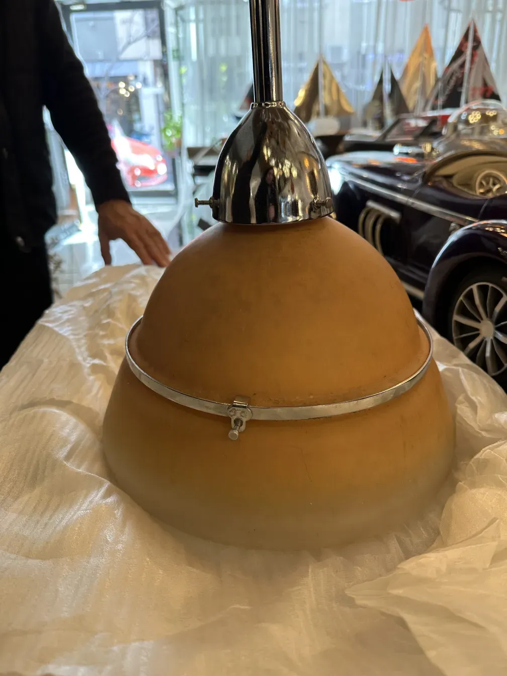 Antique hanging lamp with a distinctive design by Peter Behrens, featuring a unique finish and round base in an elegant setting.