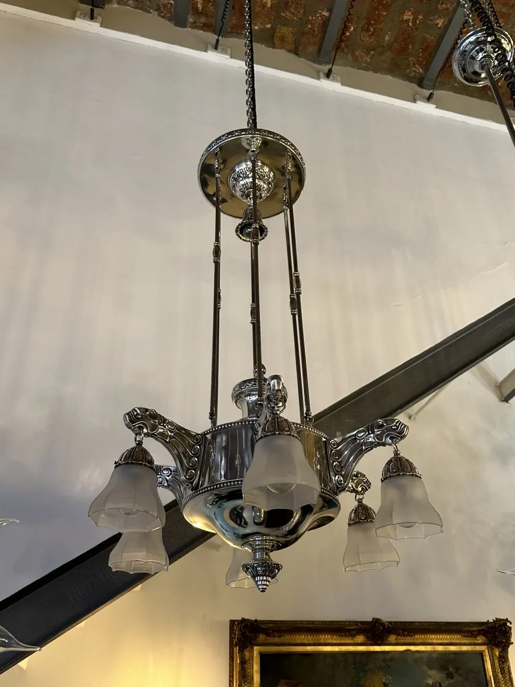 Antique hanging lamp with glass shades in a cozy setting.