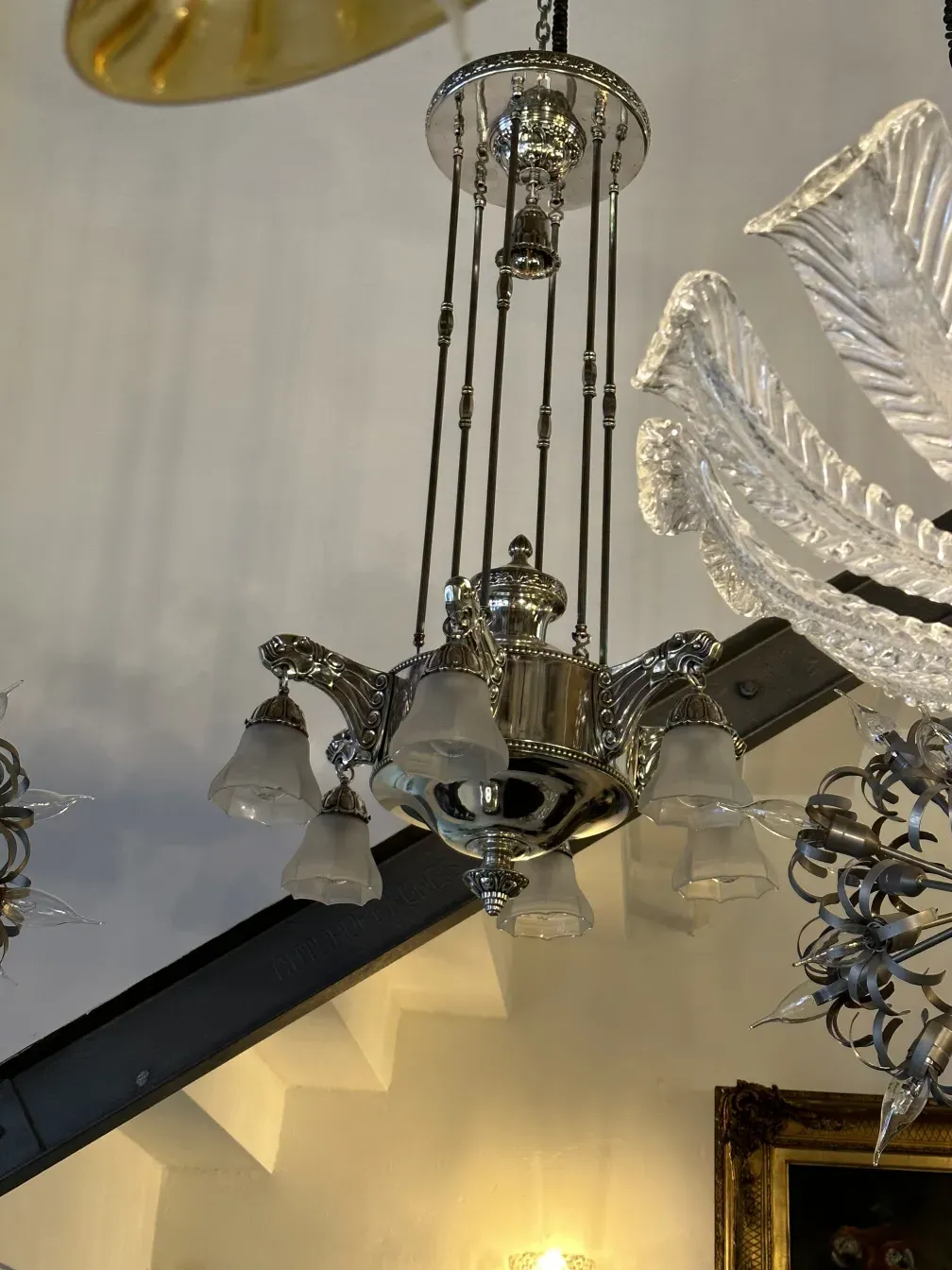 Antique hanging lamp with clear glass features, elegant setting.