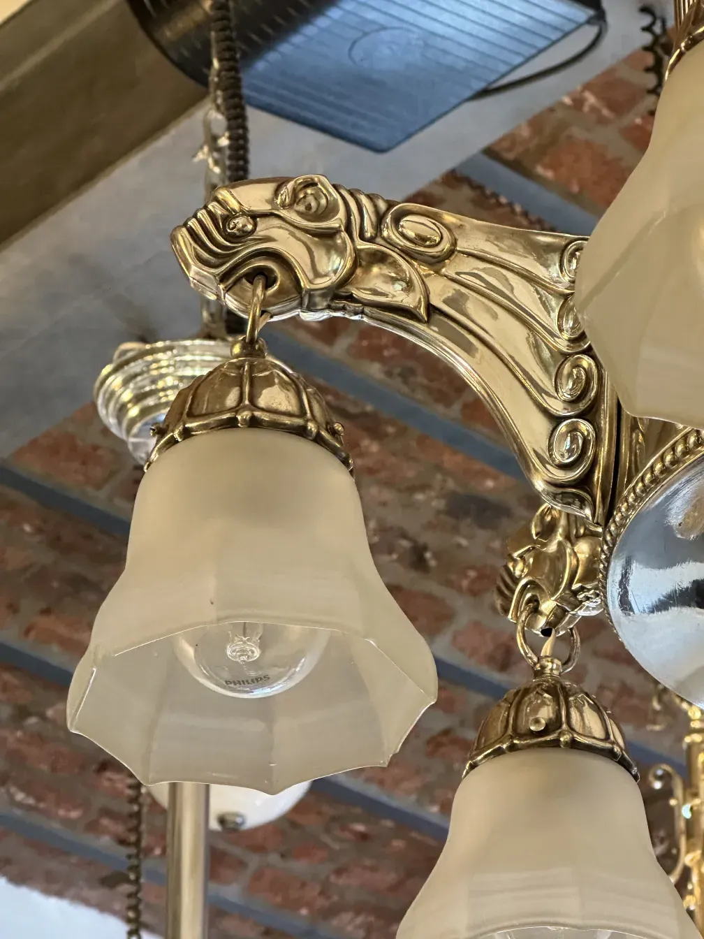 Antique hanging lamp with ornamental details and glass shade