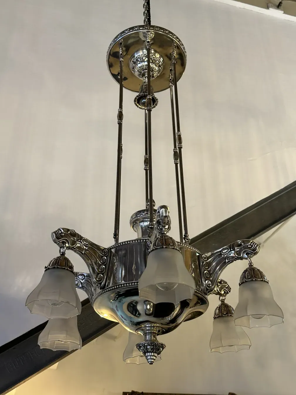 Antique hanging lamp with three shades in a cozy setting.