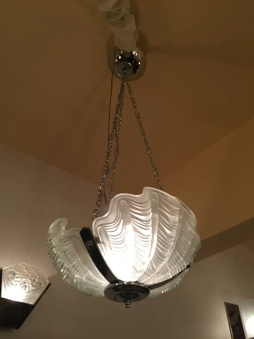 Antique hanging lamp with glossy structure and distinctive design in a cozy setting.