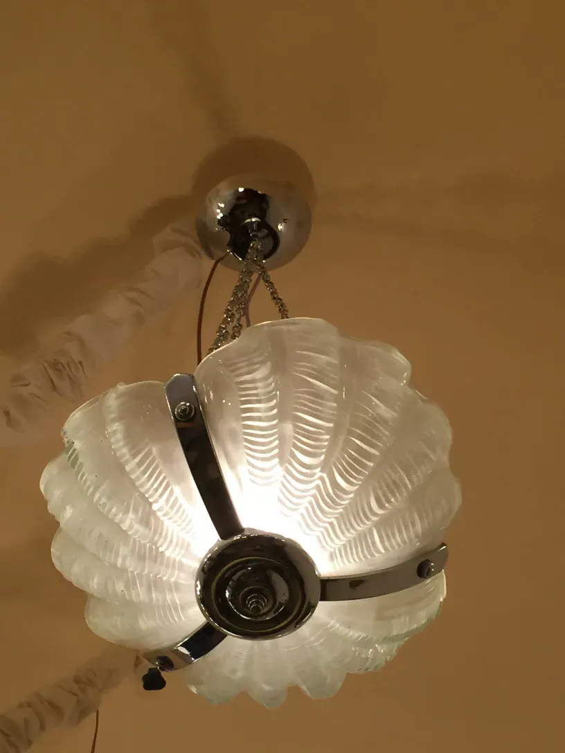 Elegant antique glass hanging lamp with silver details, creating a warm ambiance.