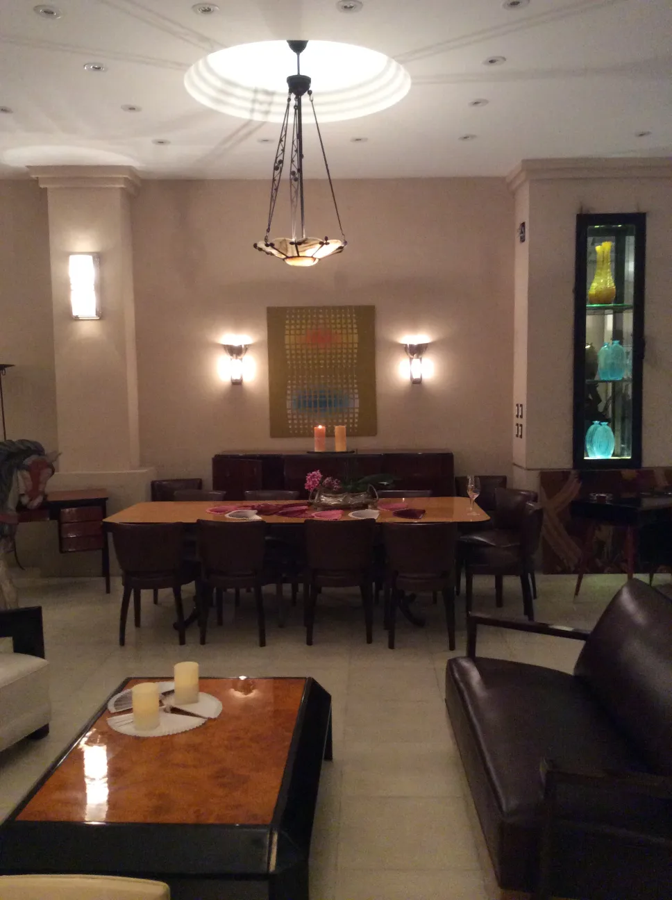 Antique hanging lamp in an elegant setting with a table and chairs.