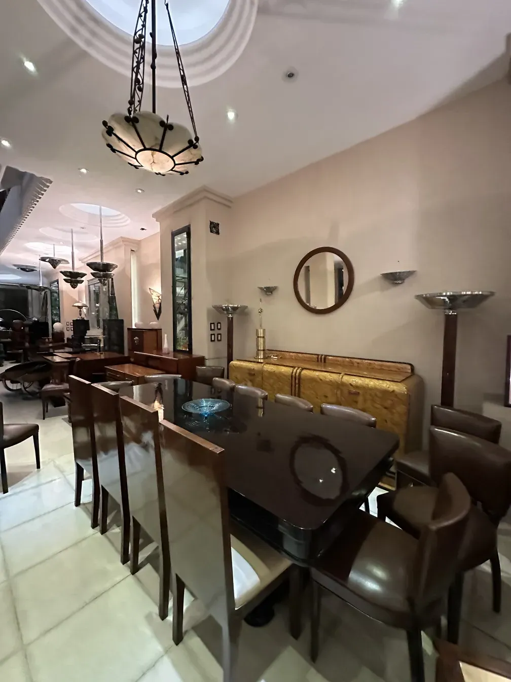 antique hanging lamp suspended in an elegant setting with dark furniture.