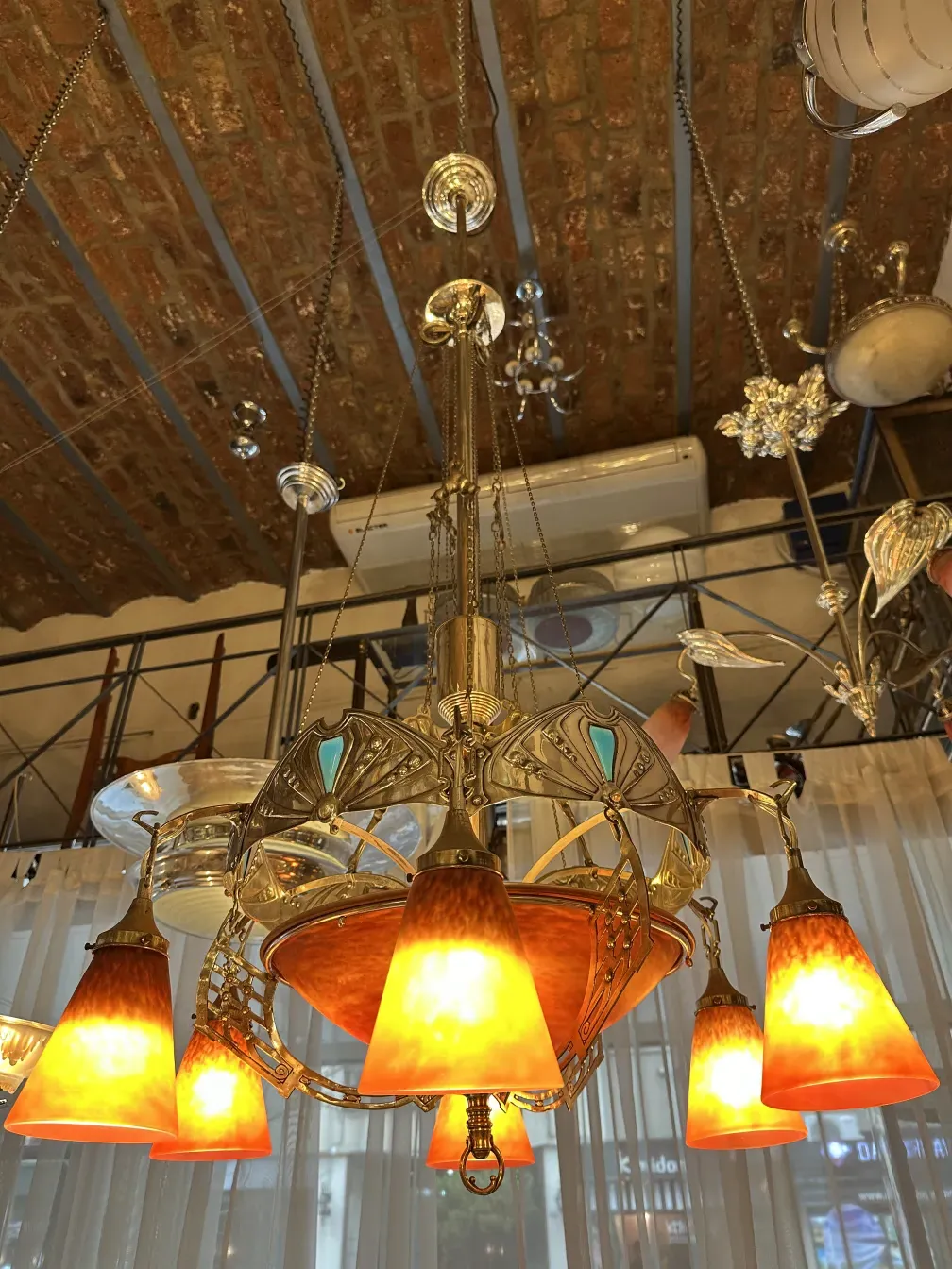 antique hanging lamp by Charles Schneider with vibrant orange lights