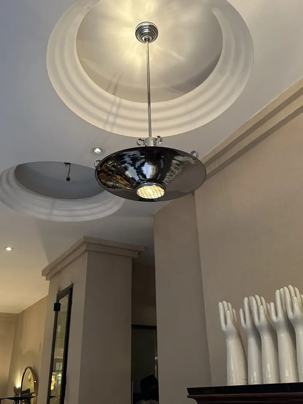 Antique hanging lamp with a shiny finish in a modern setting.