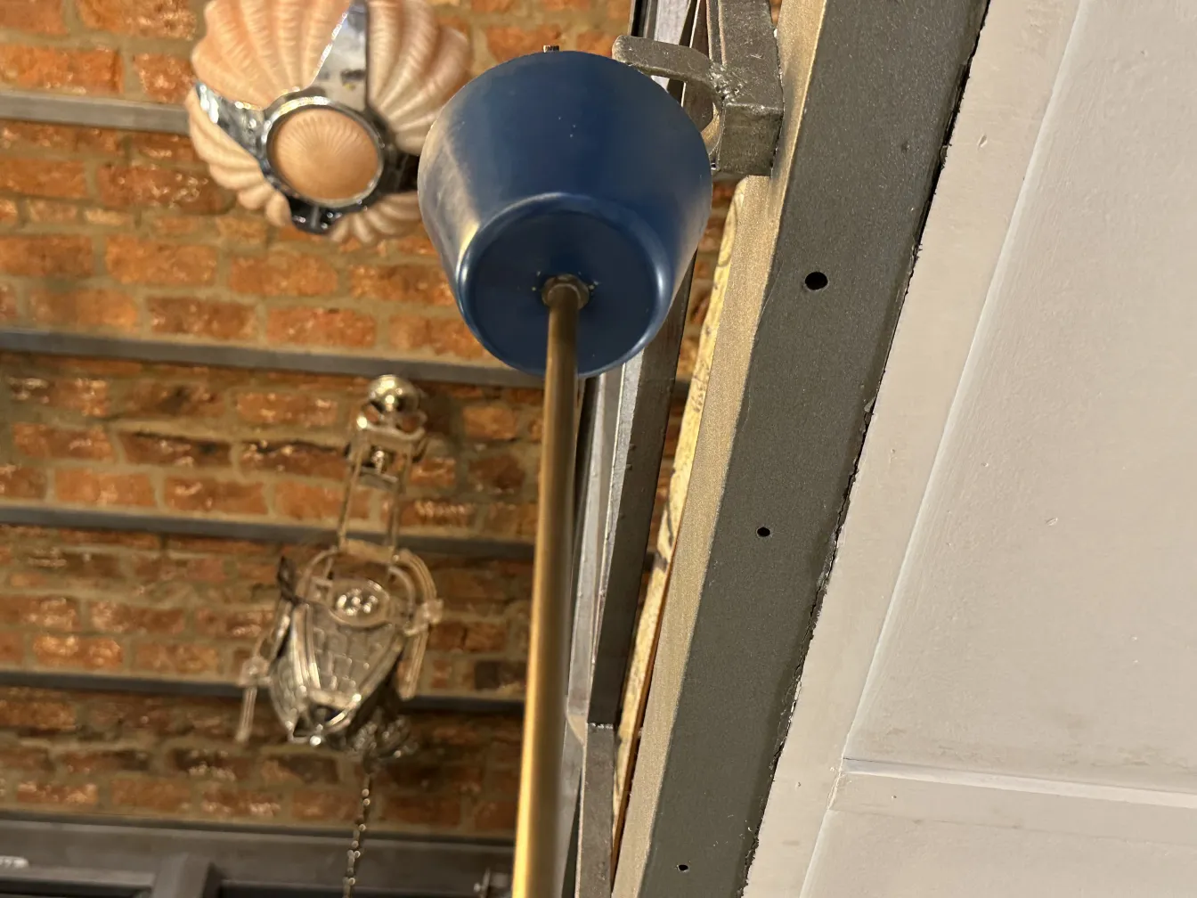 Antique hanging lamp featuring design by artist Boris Lacroix, set in an industrial background.