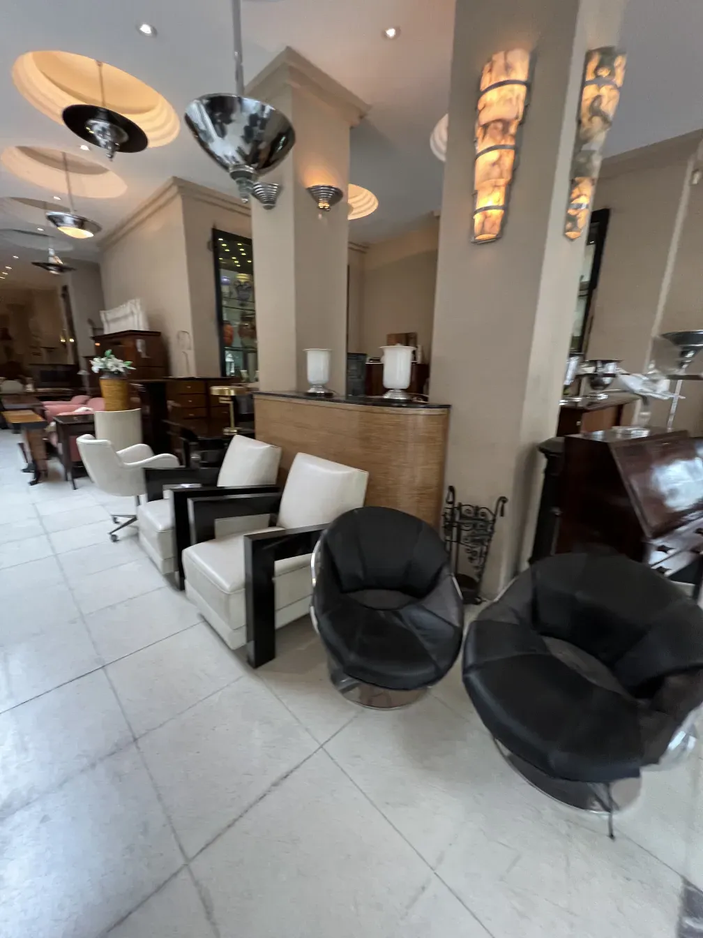 Antique hanging lamp in a modern setting with chairs