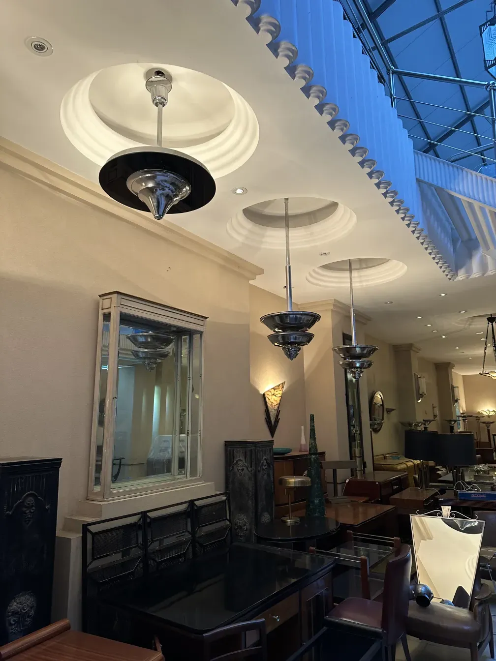 Antique hanging lamp, elegant in a decorative setting. Various furniture around.