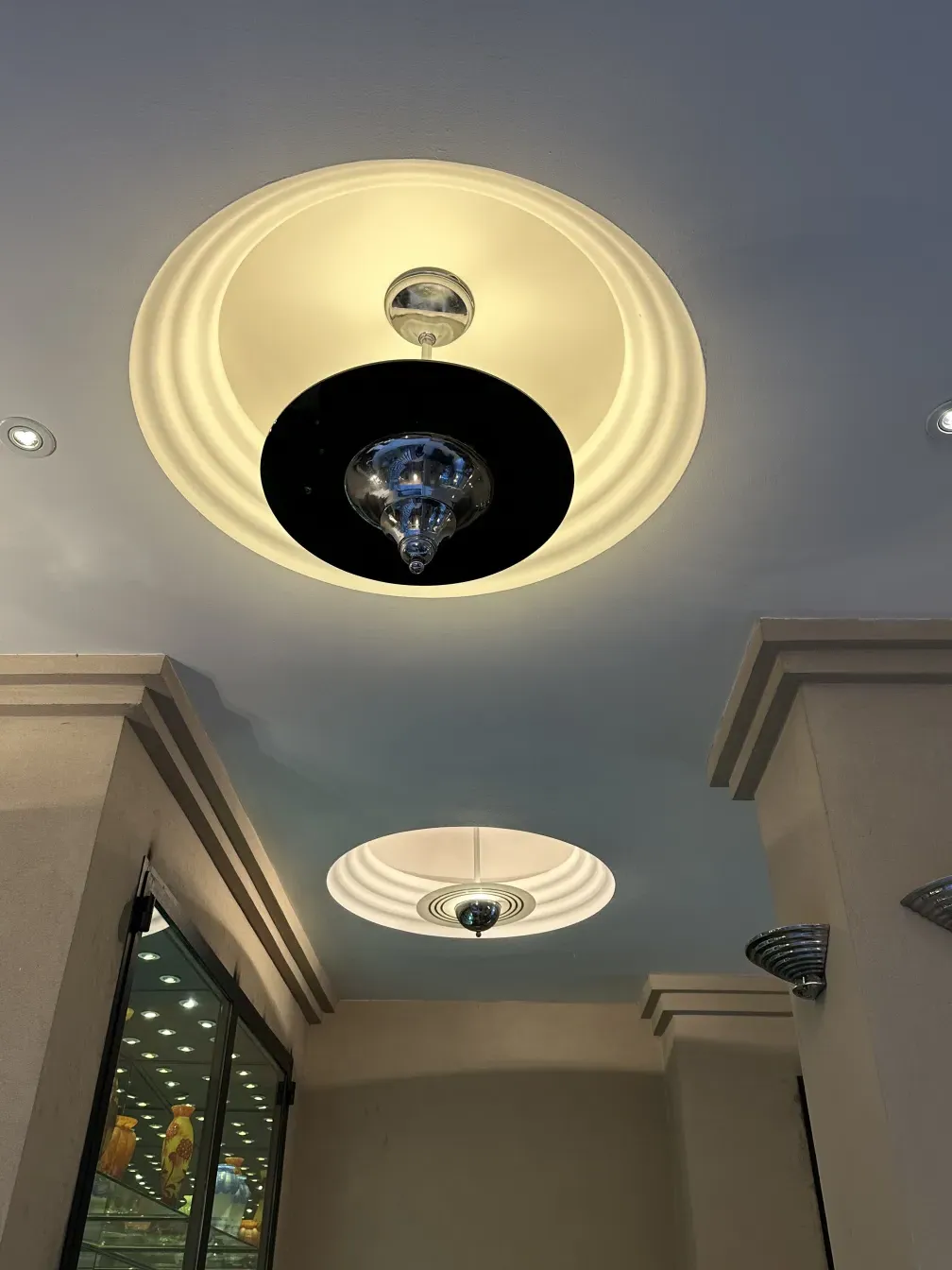 Antique hanging lamp with elegant design and soft lighting in a modern setting.