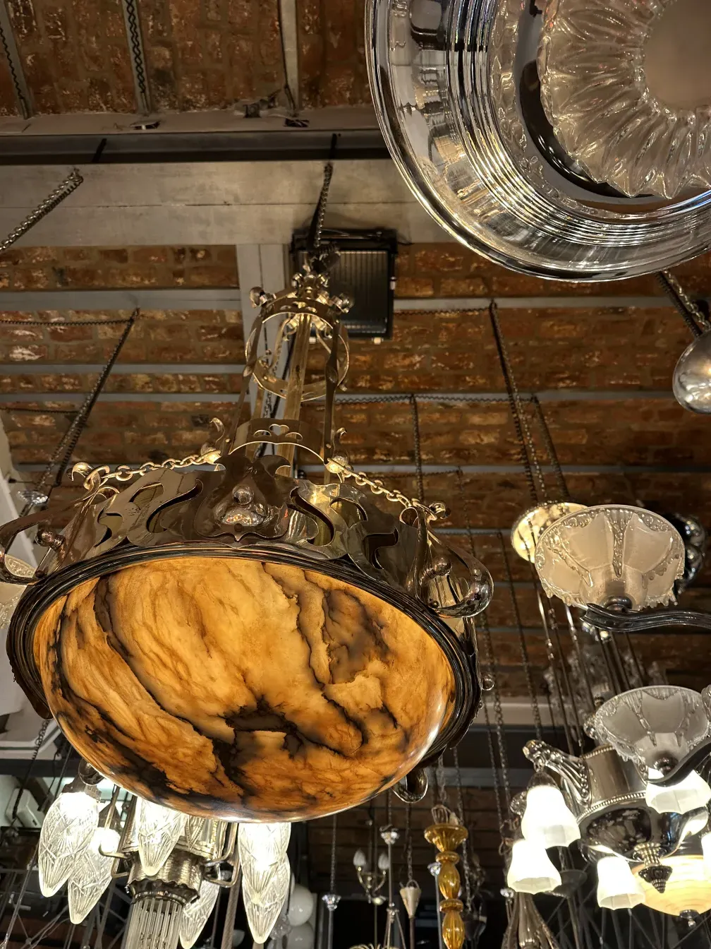 Antique hanging lamp with an ornate design and intricate details in a decorative setting.