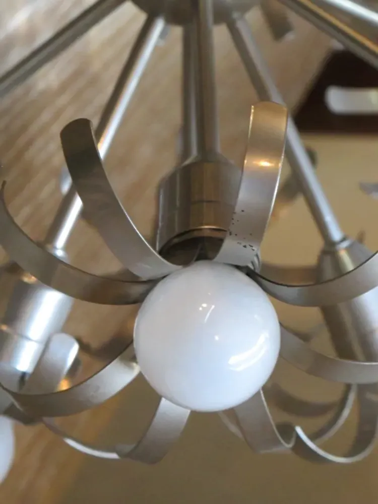 Antique hanging lamp featuring white spheres and elegant design.