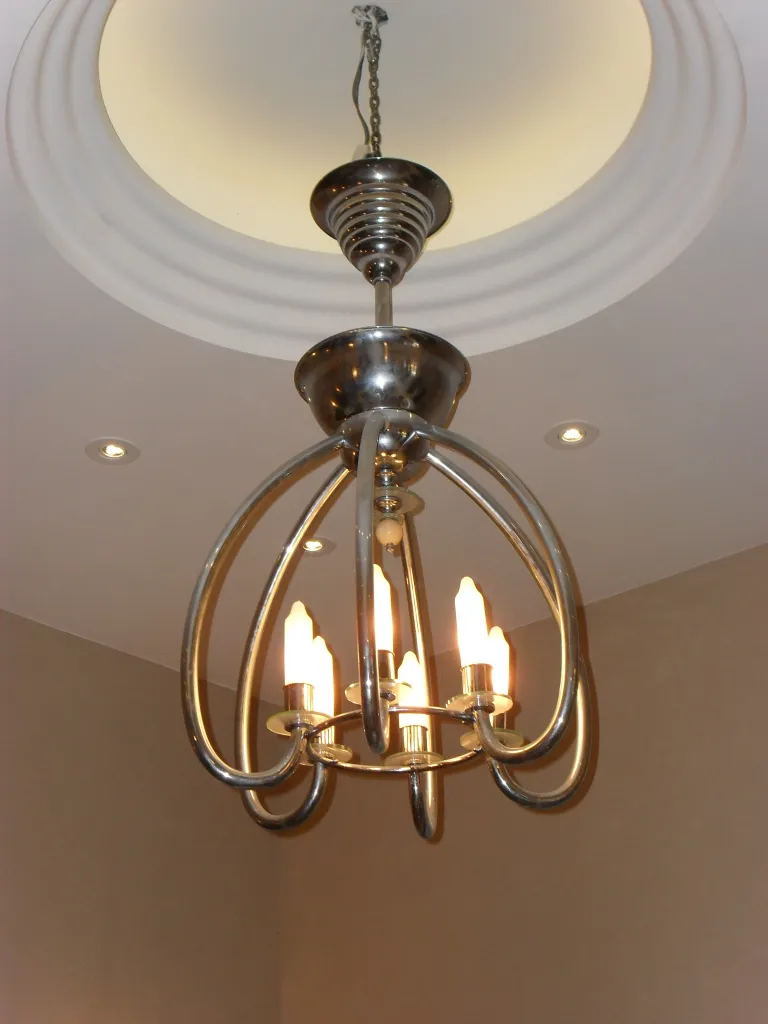 Antique hanging lamp with shiny metallic finish and modern shapes.