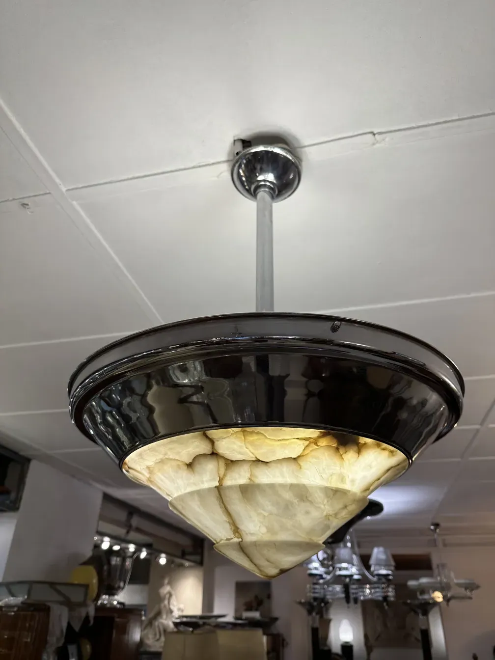 Antique hanging lamp with warm light in a stylish setting.