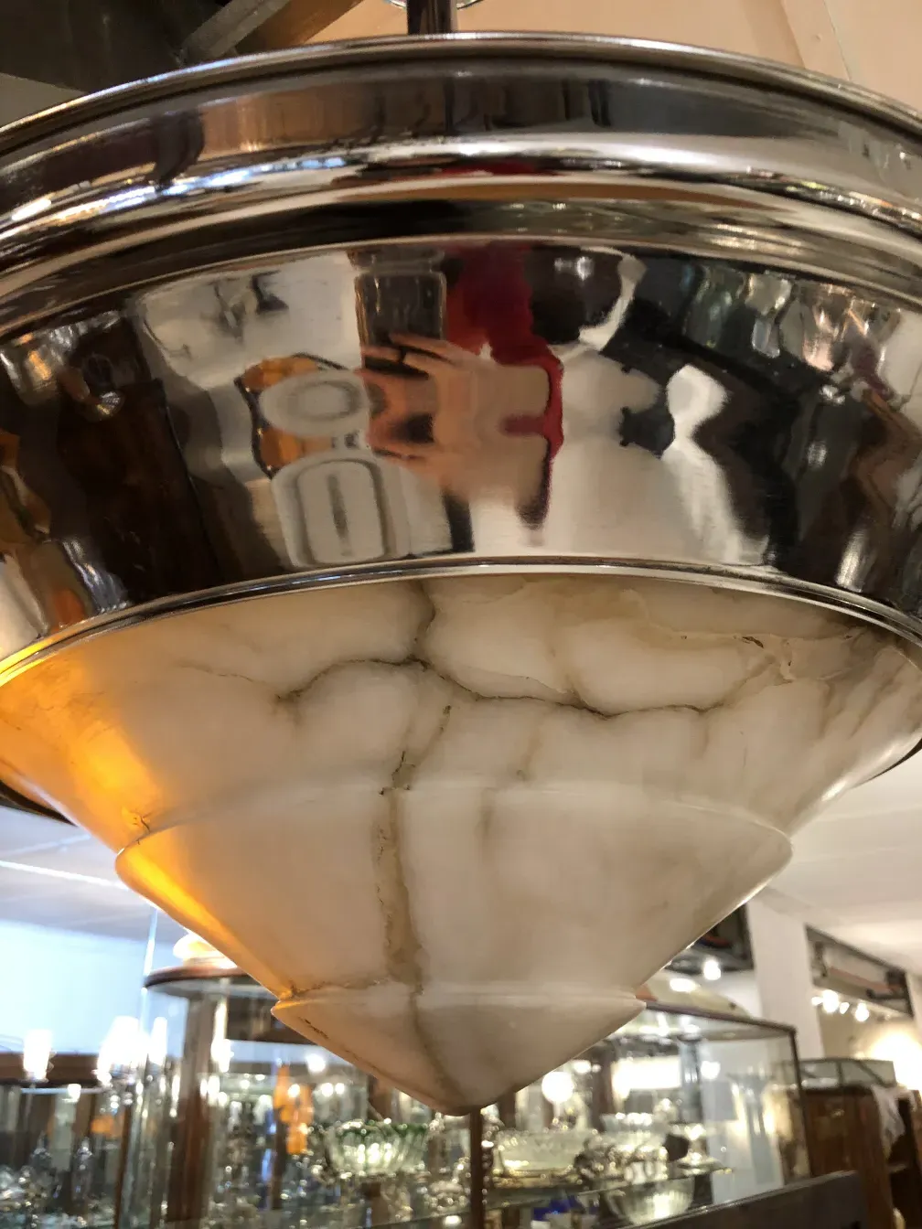 Antique hanging lamp with glossy finish, brightening the space.