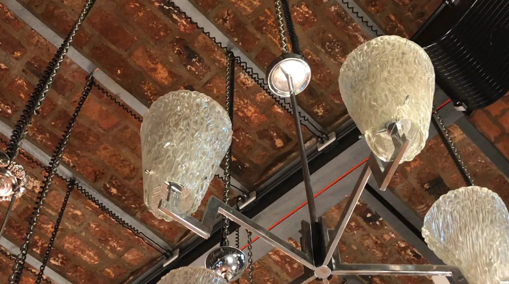 Antique hanging lamp with a unique design, enhancing a rustic atmosphere.