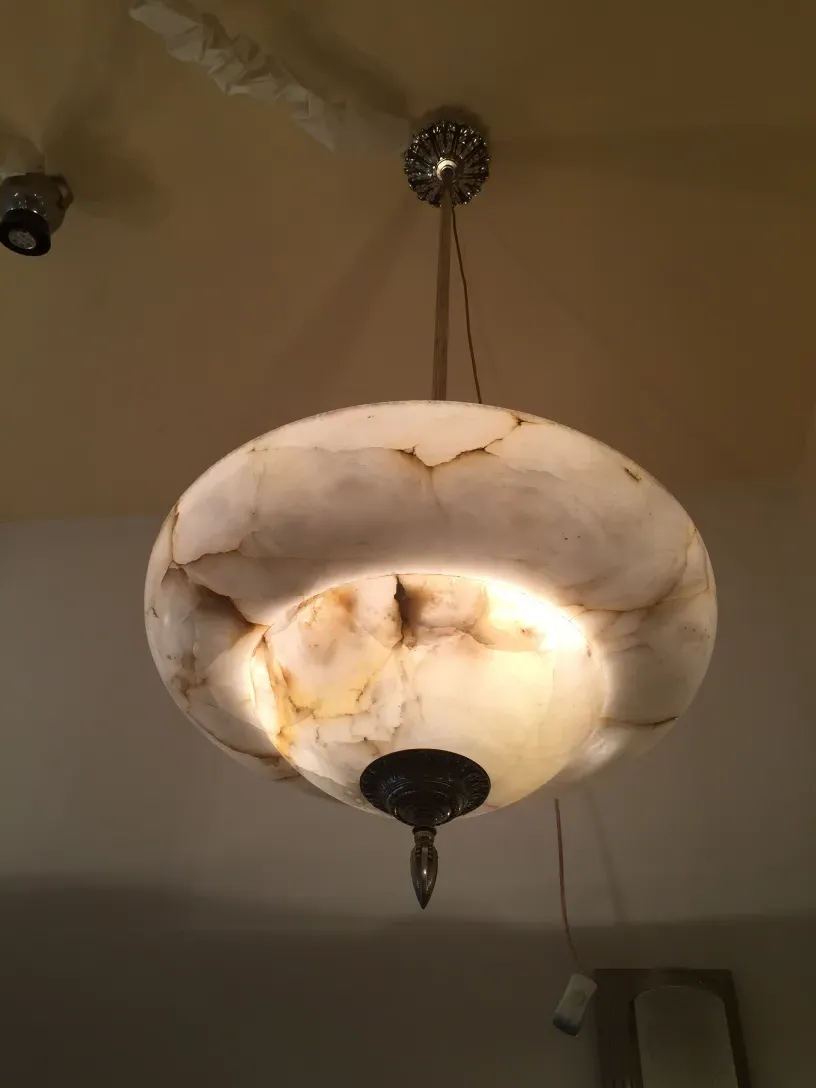Antique hanging lamp in alabaster with a soft glow