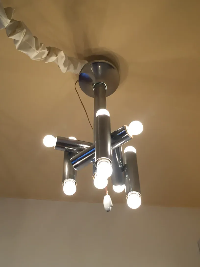 Antique hanging lamp with multiple bulbs in a warm atmosphere.