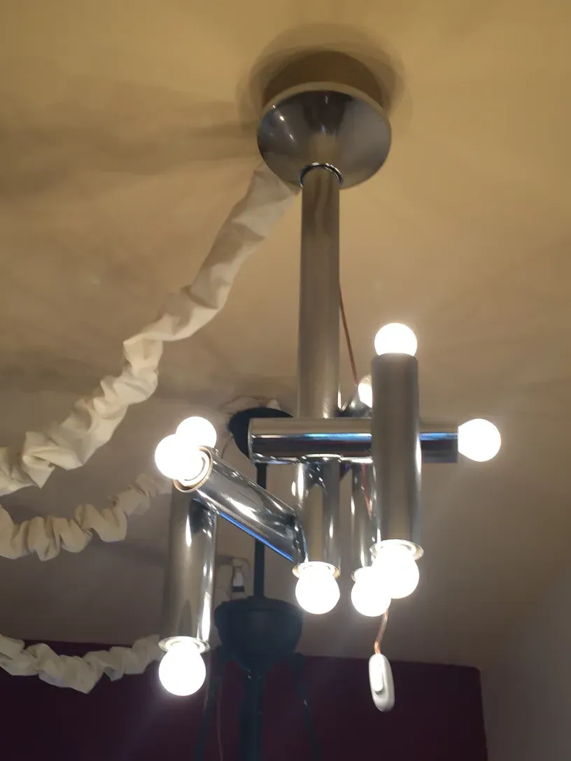 Antique hanging lamp with multiple round lights in a modern setting