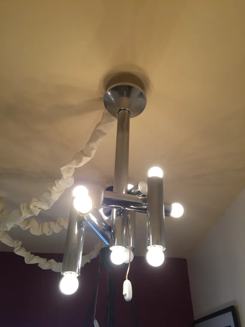 antique hanging lamp with light arms and shiny fixture