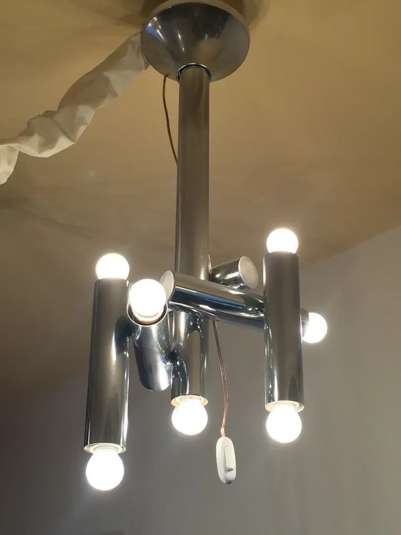 Antique hanging lamp with multiple bulbs illuminating the space.